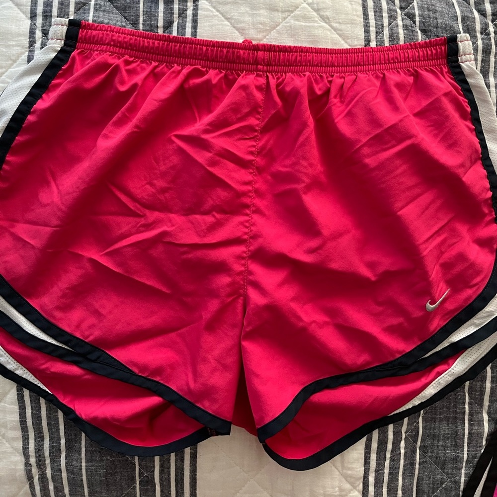 Pink Nike athletic shorts.